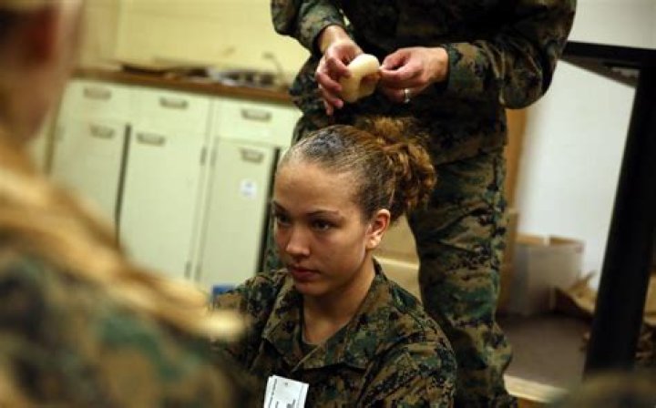 Can female Marines shave their heads?