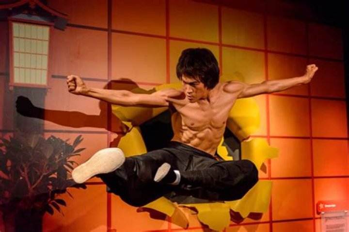 How did Bruce Lee break his back?