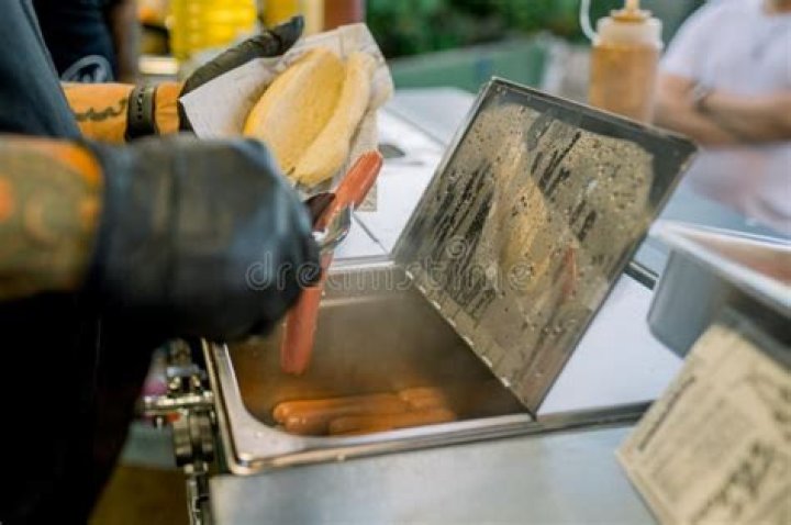 How do street vendors cook hot dogs?
