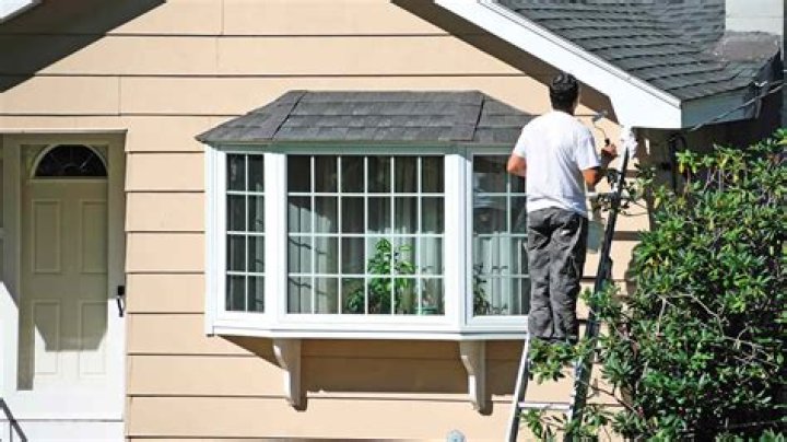 Is it better to roll or spray exterior paint?