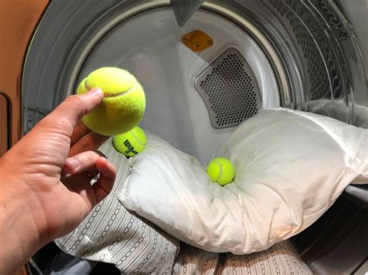 Why do you put a tennis ball in the dryer?